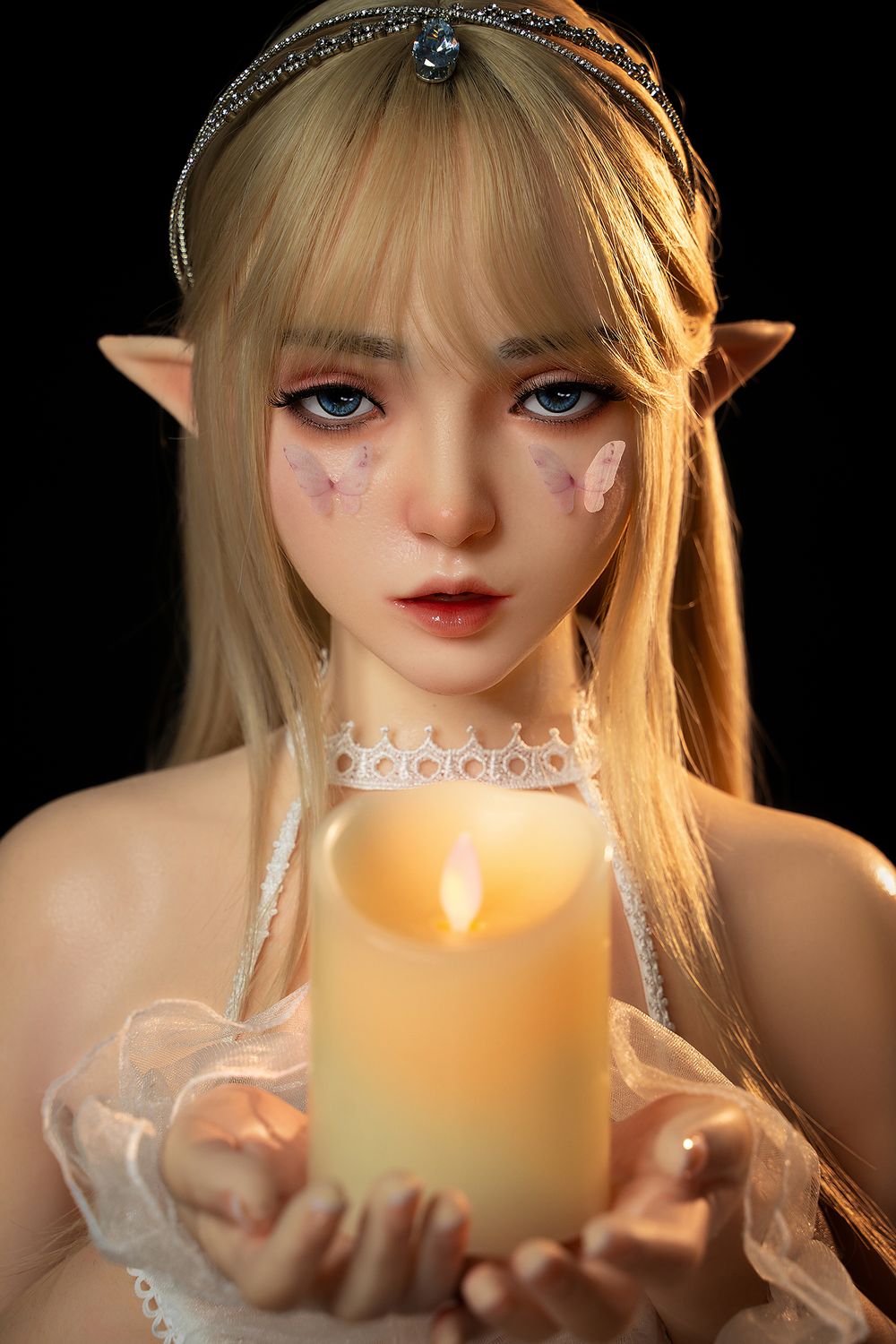 SY DOLL 150cm Full Silicone Elf Anime Cosplay Doll Joy with long blonde hair, diamond crown, butterflies on her face and body, dressed in white organza lingerie, sheer wrist flowers, and embroidered leaf-patterned stockings, holding a scented candle03