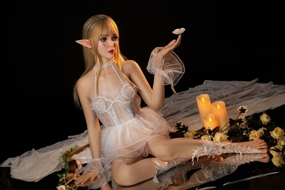 SY DOLL 150cm Full Silicone Elf Anime Cosplay Doll Joy with long blonde hair, diamond crown, butterflies on her face and body, dressed in white organza lingerie, sheer wrist flowers, and embroidered leaf-patterned stockings, holding a scented candle14